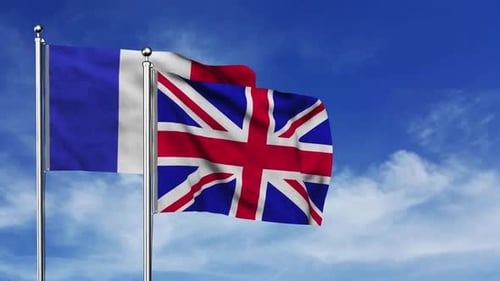 French and United Kingdom Flags Waving Against Blue Sky