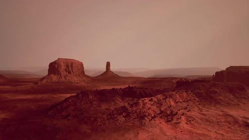 A Stunning Desert Landscape with a Majestic Rock Formation in the Distance