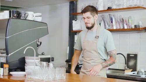 Friendly Barista Talking in Coffee Shop