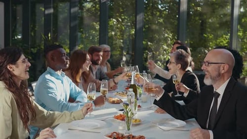 Diverse Colleagues Toasting Celebration at Elegant Long Table