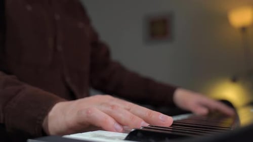Adult Hands Playing the Piano Keys Close Up