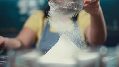 Person Sifting White Flour in a Kitchen