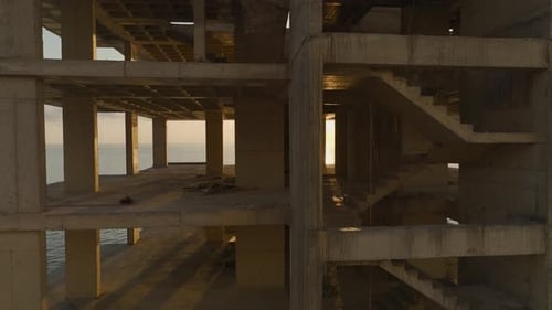 Aerial View The Skeleton of a Multistory Building Stands Against the Ocean Backdrop Ready for Elite