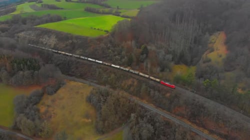 Freight Train Traversing Rural Landscape Aerial View