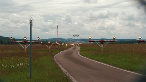 Two engine jet plane is landing at landing strip and touching ground in airport