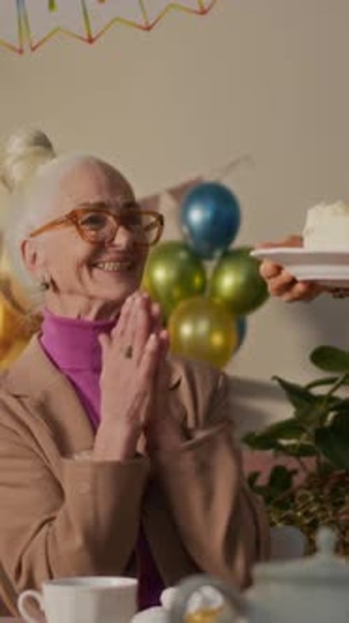 Senior woman celebrates 70th birthday with family at home