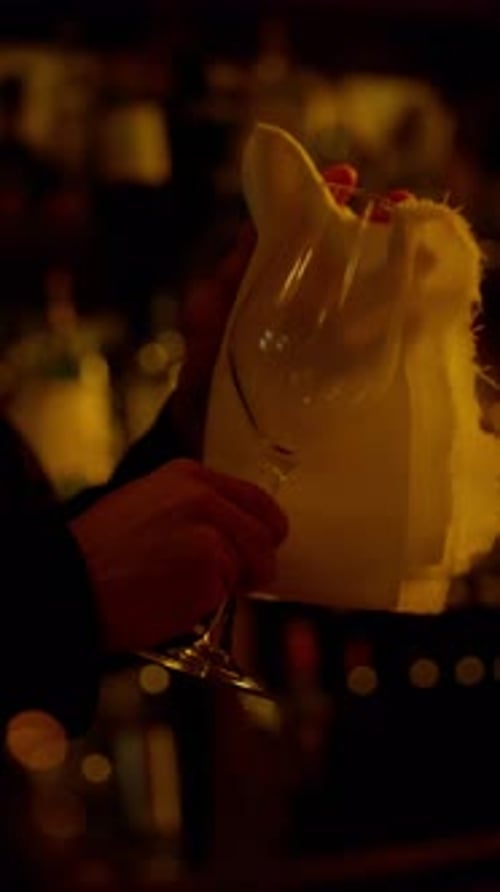 Bartender Polishing Glass in Ambient Bar