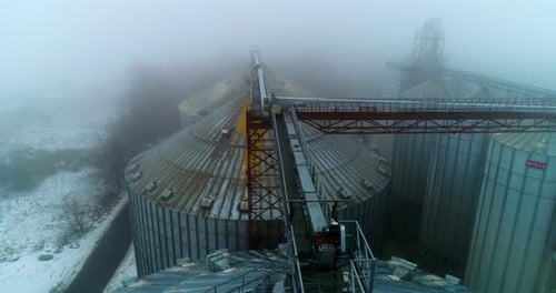 Foggy Aerial View of Grain Silos in Winter