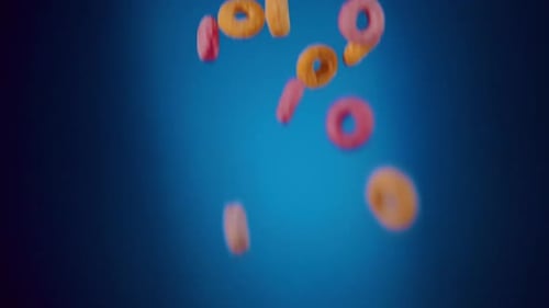 Breakfast Cereals Fruity Loops Falling in Slo- Motion with blue background