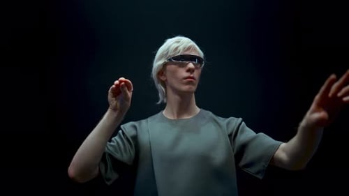 Man with futuristic glasses interacts with virtual interface