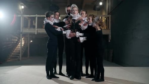 Mimes Performing Together in Dark Theater Setting