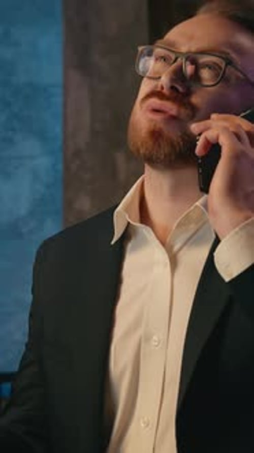 Irritated Tired Exhausted Business Man Talking Mobile Phone in Evening Office Caucasian Businessman