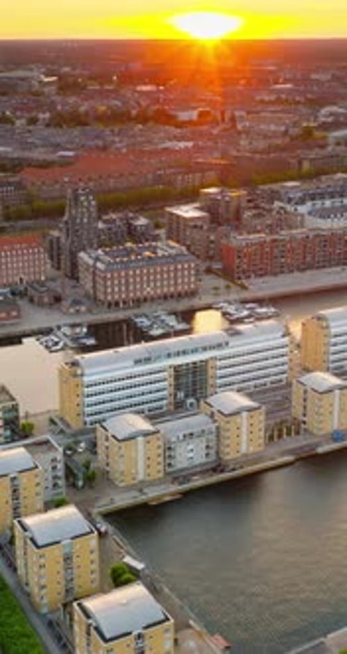 Aerial drone view of Nordhavn harbour area at the coast of the Oresund at sunset. Vertical