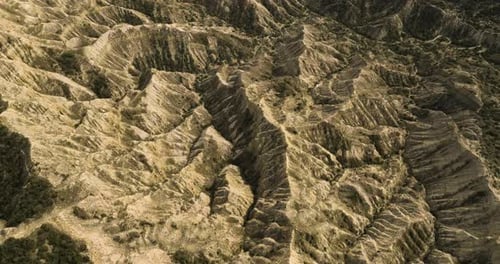 Sunlit eroded sandstone hills and ravines in Vashlovani, Georgia.