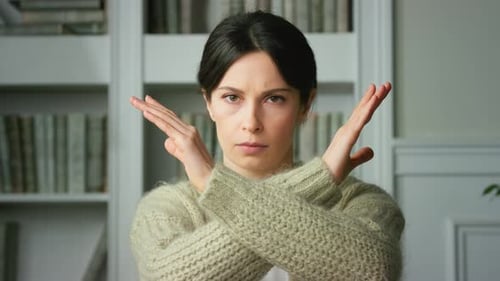 Woman Holds Arms in X Gesture of Refusal