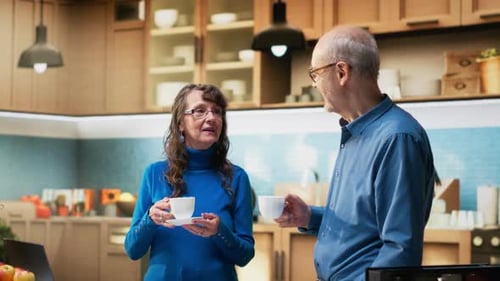 Mature Couple Enjoying Coffee Together in Kitchen