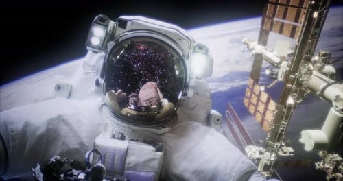 Astronaut Performing a Spacewalk Near the International Space Station