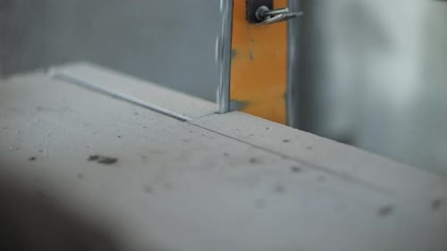 Electric Saw Cutting Through Aerated Concrete Block