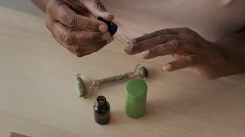 Unrecognizable Woman Using Cuticle Oil
