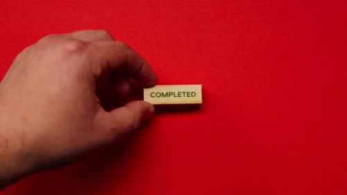 a Yellow Warm Background Without Shadows the Male Hand Laid Wooden Cubes with Colored Words Laid Out