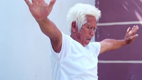 Senior Man Stretching Arms For Exercise Outside