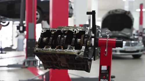 Auto Mechanic Disassembles Engine Block in Garage Detailed View of Cylinder Crankshaft Engine Parts