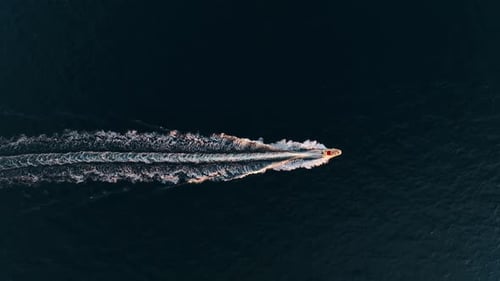 Vacation and leisure. Aerial view on fast boat on blue Mediterranean sea at sunny day.