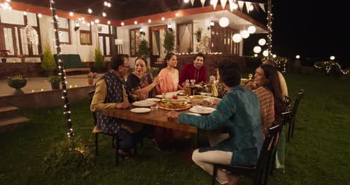 Family Enjoying Diwali Dinner at Home at Night