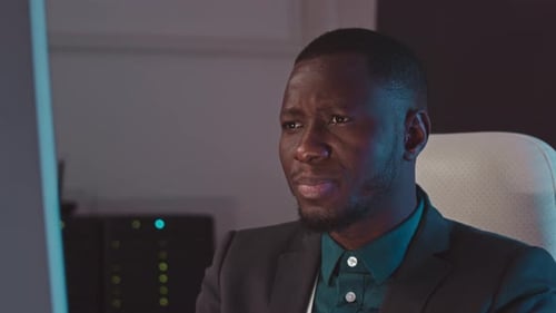 Black Man Hacking Computer in Cybersecurity Agency