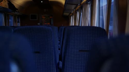 Train with empty seats. Interior view of train with blue upholstered seats.