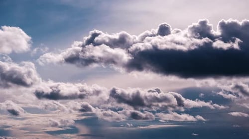 Fluffy White Clouds Floating in a Blue Sky