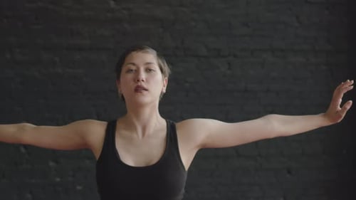 Young Woman Dancing Fluidly in Studio