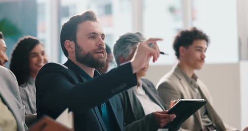 Diverse Adults at a Meeting Raise Hands