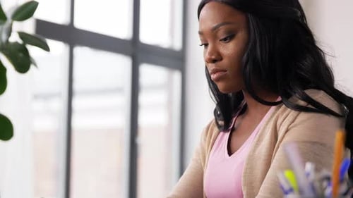 Tired african american woman stressed working remotely from her home office