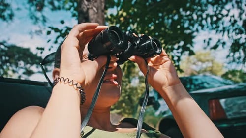 Woman Using Binoculars for Exploration in Nature