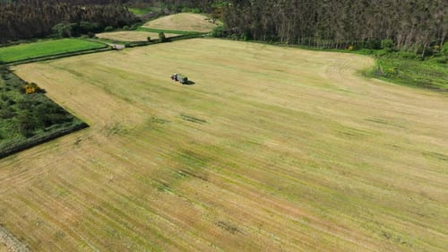 Aerial View Of A Tractor Working In The Field - Drone Shot