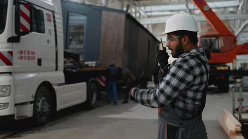 Construction Worker Coordinating Modular Home Loading Process