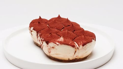 Close up of Creamy Tiramisu Dessert on White Plate