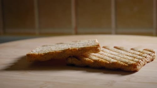 Grilled Toast on Wood Cutting Board in Kitchen