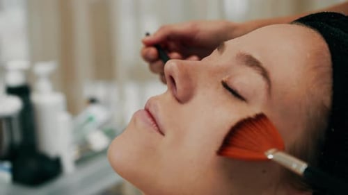 Young Woman Receives a Rejuvenating Facial Treatment