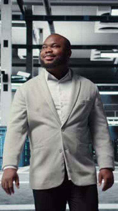 Vertical Video Smiling Engineer Walking in Data Center Checking Hardware for System Stability