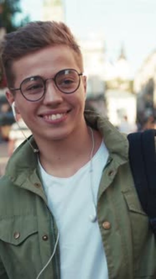 Young Man Listening to Music in City