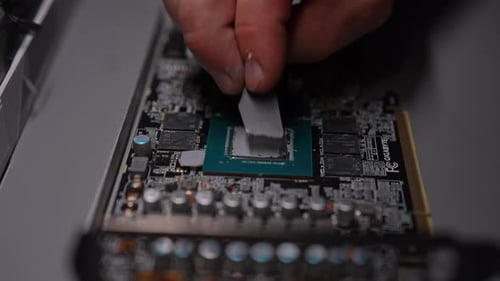 Applying Thermal Paste to Computer Circuit Board