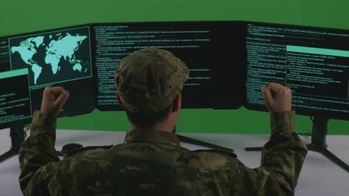 Back View Of Man Soldier Celebrating While Write Code With Multiple Computer Screens In Green Screen