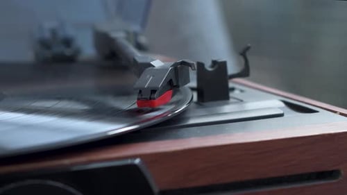 View of vinyl record spinning on turntable while music playing. Close up.
