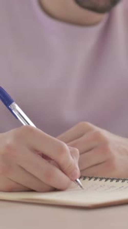 Close Up of Male Hand Writing on Paper, Vertical Video