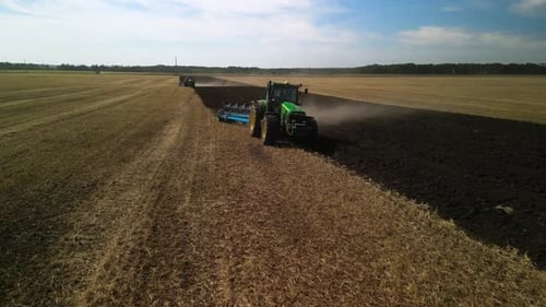 Tractors plowing the field in Ukraine