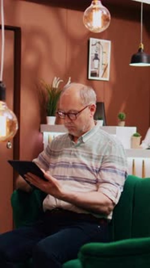 Vertical Video Senior Person Using Modern Tablet
