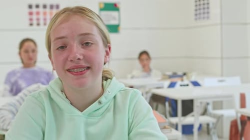 Teen Student Smiling in a Classroom Setting