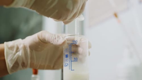 Adding Solution to Medical Beaker for Research